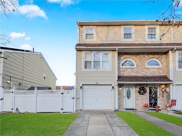 multi unit property with a front lawn and a garage