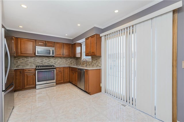 kitchen with sink, stainless steel appliances, tasteful backsplash, light tile patterned floors, and ornamental molding