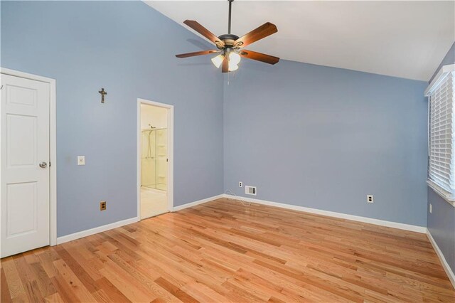 unfurnished bedroom with connected bathroom, high vaulted ceiling, light hardwood / wood-style flooring, and ceiling fan