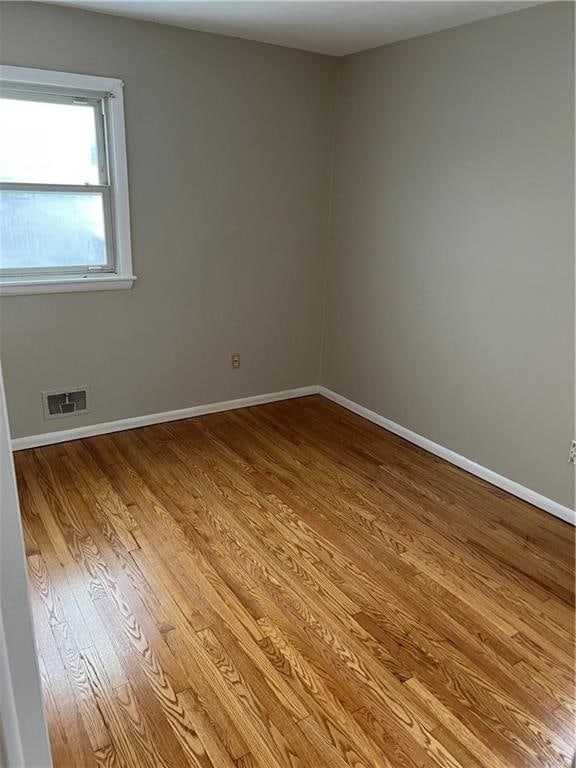 unfurnished room with light hardwood / wood-style floors