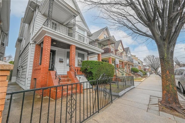 view of front of home with a balcony and a porch