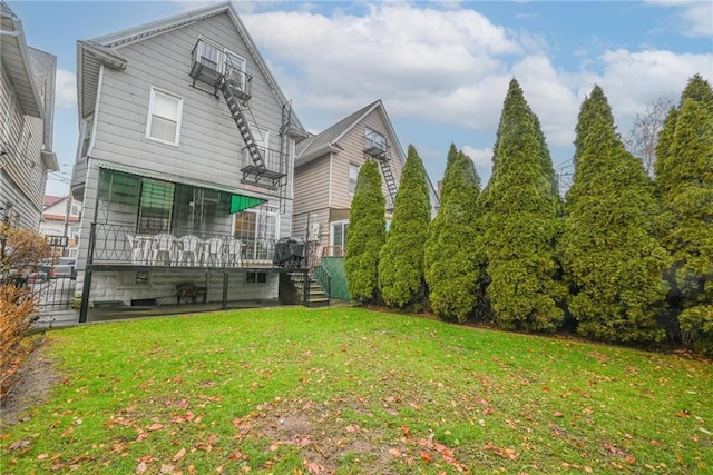 back of house with a yard, stairway, and a wooden deck