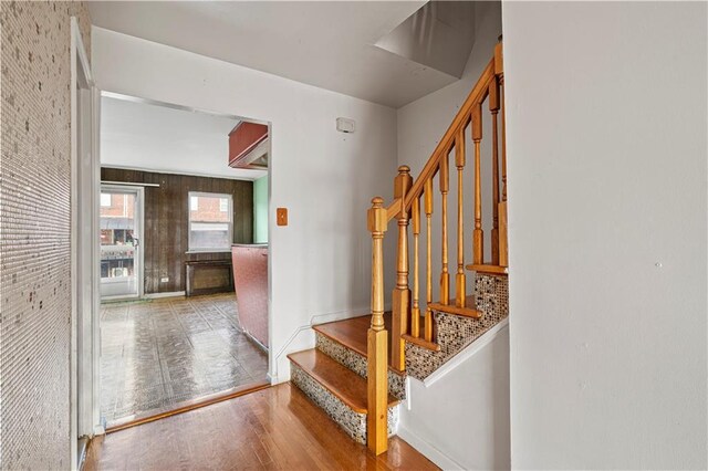 staircase with hardwood / wood-style flooring