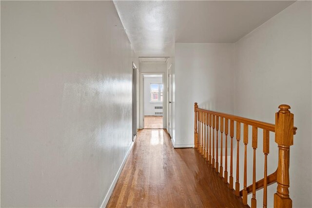 hallway featuring radiator and hardwood / wood-style floors