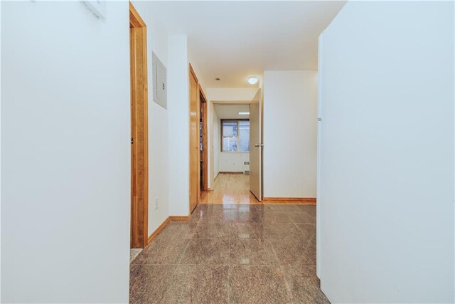 hall with granite finish floor and baseboards