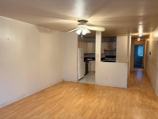 unfurnished living room with ceiling fan and light hardwood / wood-style floors