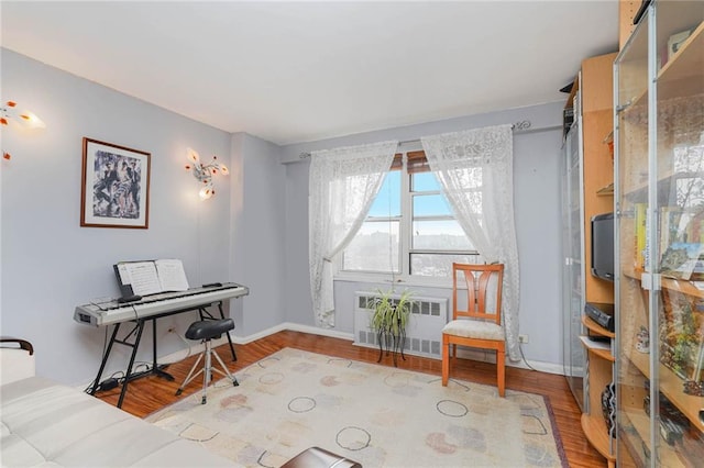 sitting room featuring hardwood / wood-style flooring and radiator heating unit