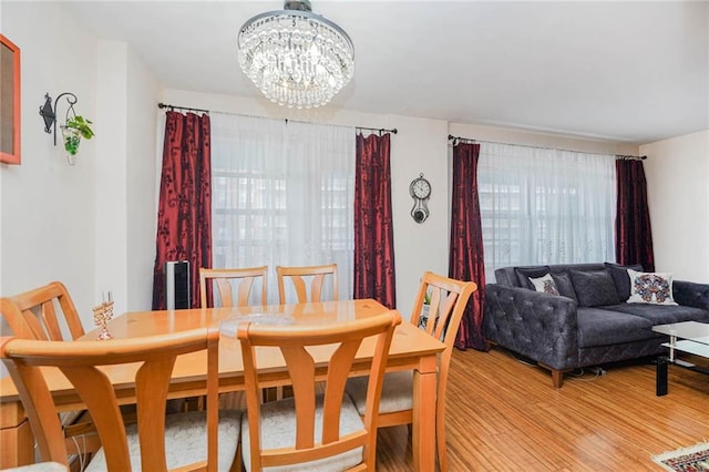 dining space featuring a notable chandelier and light hardwood / wood-style flooring