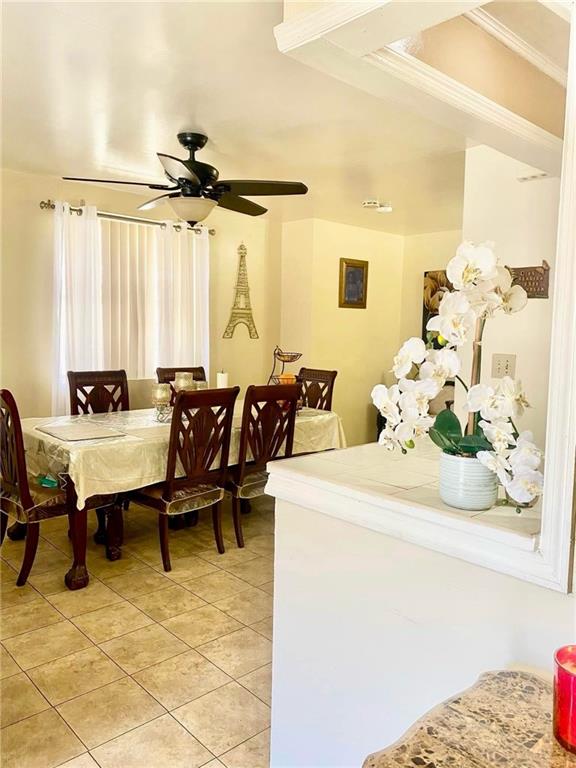 153 Hendrix St, Brooklyn, NY 11207 - dining space featuring crown molding, light tile patterned floors, and a ceiling fan