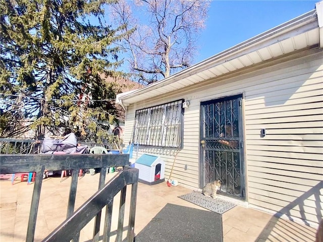 view of exterior entry with a patio and outdoor dining space