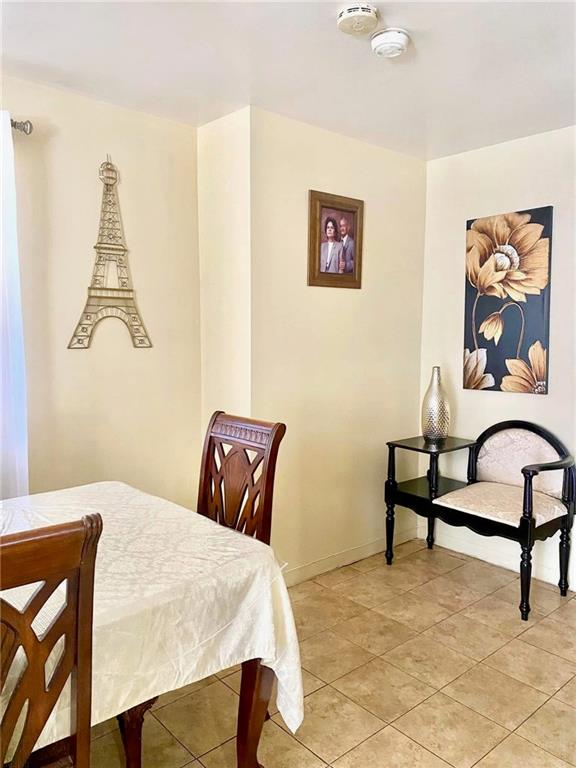 153 Hendrix St, Brooklyn, NY 11207 - dining space featuring baseboards and light tile patterned flooring
