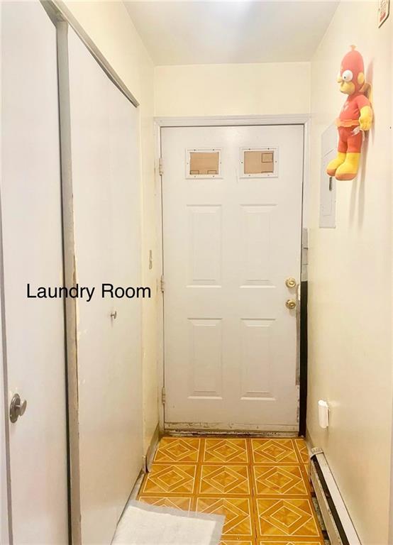 153 Hendrix St, Brooklyn, NY 11207 - doorway to outside featuring a baseboard heating unit