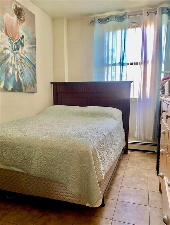 153 Hendrix St, Brooklyn, NY 11207 - bedroom featuring baseboard heating and light tile patterned flooring