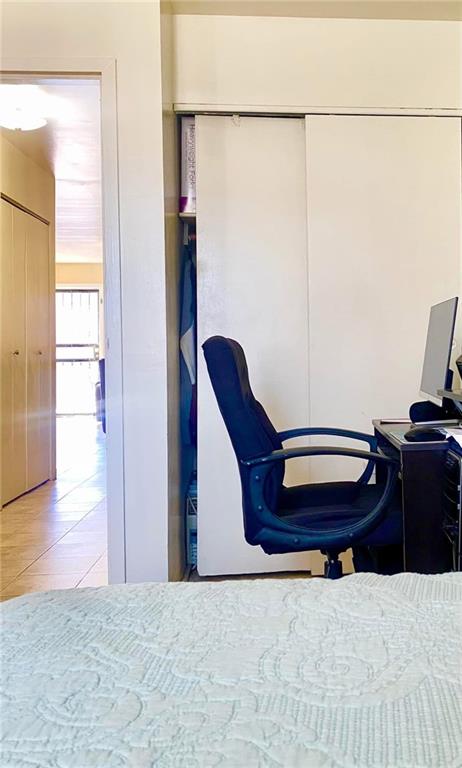 153 Hendrix St, Brooklyn, NY 11207 - bedroom featuring a closet, tile patterned flooring, and a desk