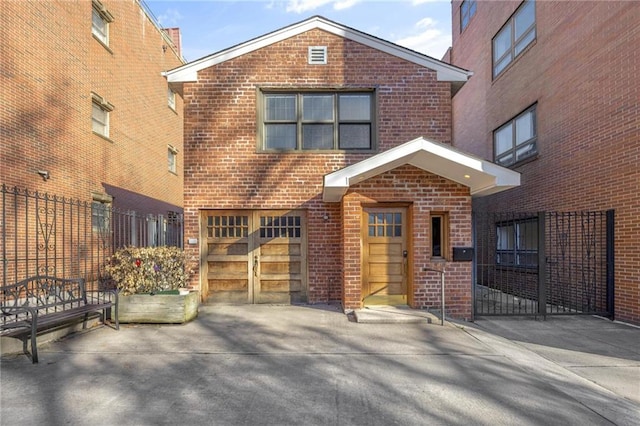 view of front of house with fence and brick siding