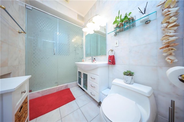 bathroom featuring walk in shower, vanity, tile walls, tile patterned flooring, and toilet