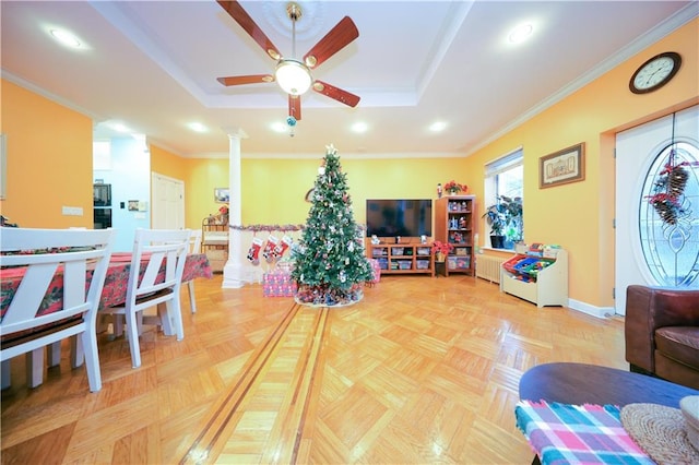 living room with parquet flooring, decorative columns, and a raised ceiling