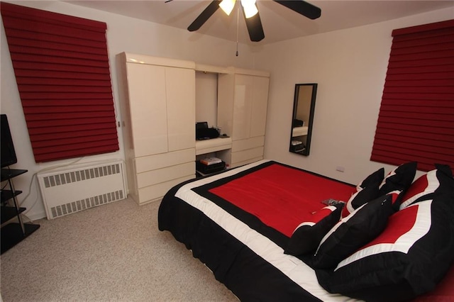bedroom with ceiling fan, radiator heating unit, and carpet floors