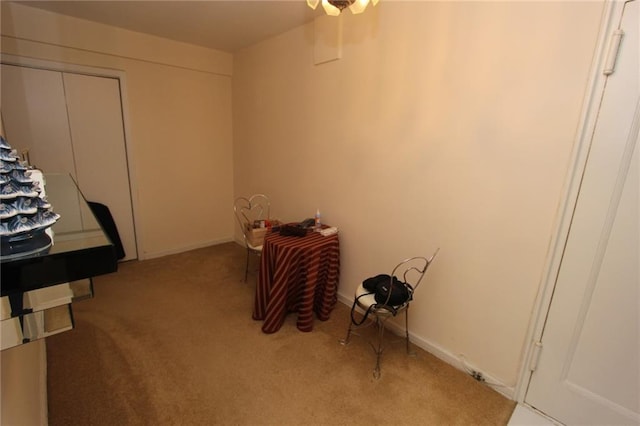 miscellaneous room featuring light colored carpet and baseboards