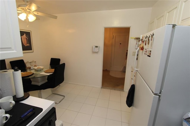 dining area featuring light tile patterned floors and ceiling fan
