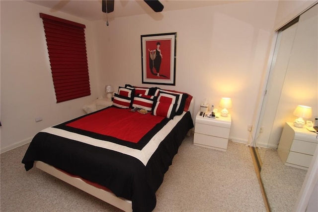 bedroom with ceiling fan, a closet, carpet flooring, and baseboards