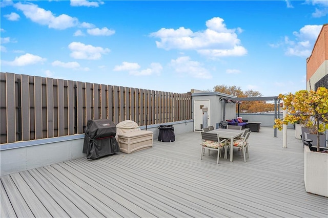 wooden deck with a grill and outdoor dining area