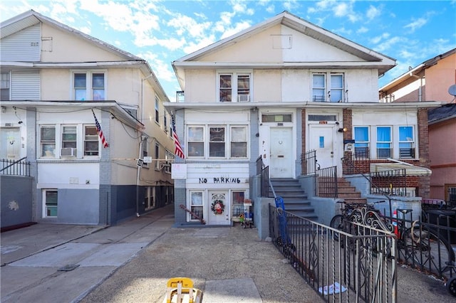 3022 Brighton 6th St, Brooklyn, NY 11235 - view of front of house featuring stucco siding and cooling unit