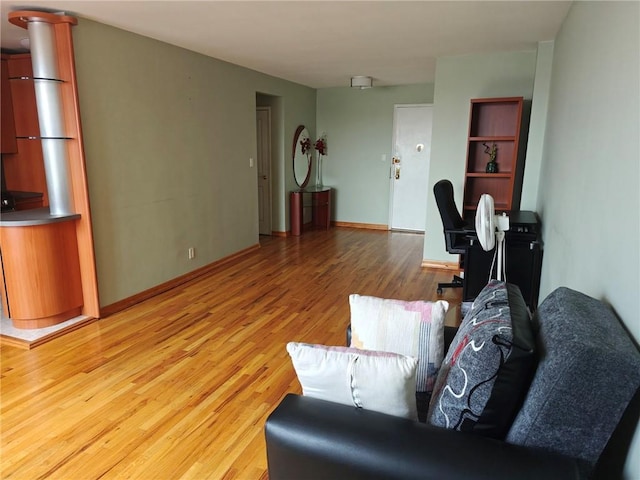 living room with light wood-style flooring and baseboards