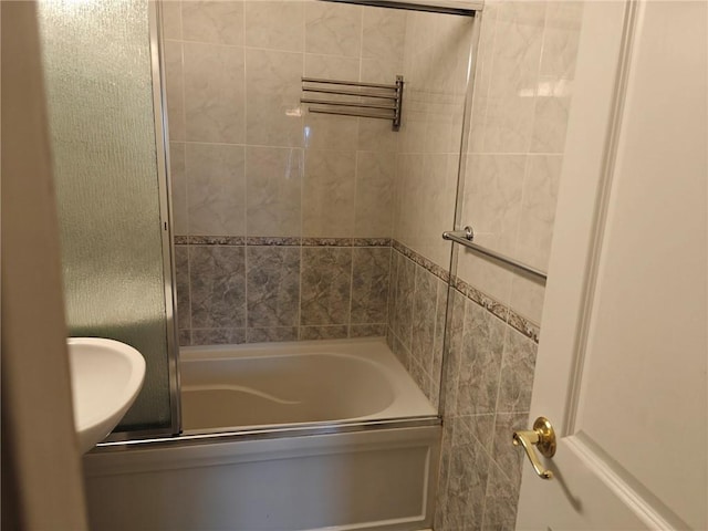 bathroom featuring bath / shower combo with glass door