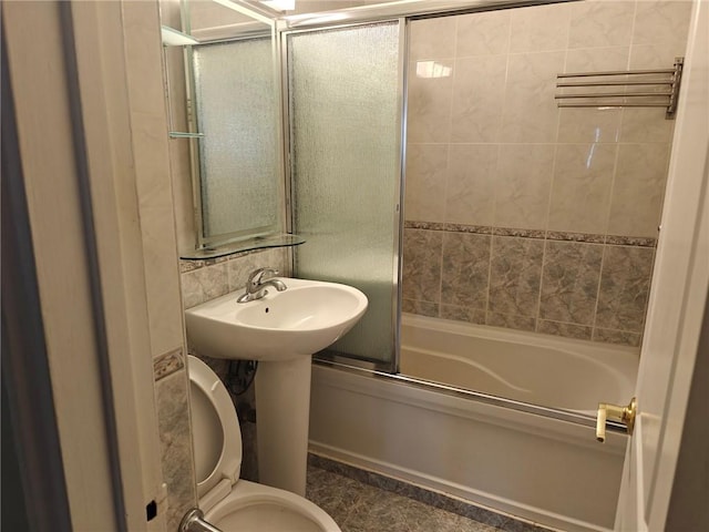 full bath with toilet and combined bath / shower with glass door