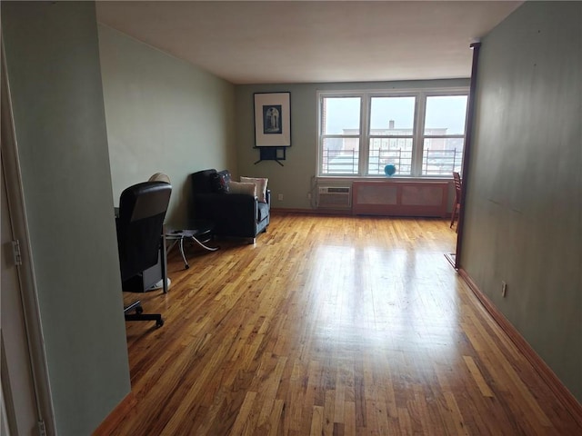 office space with a wall unit AC and wood finished floors