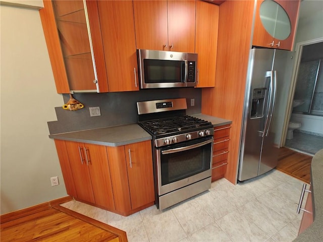 kitchen with stainless steel appliances and brown cabinetry