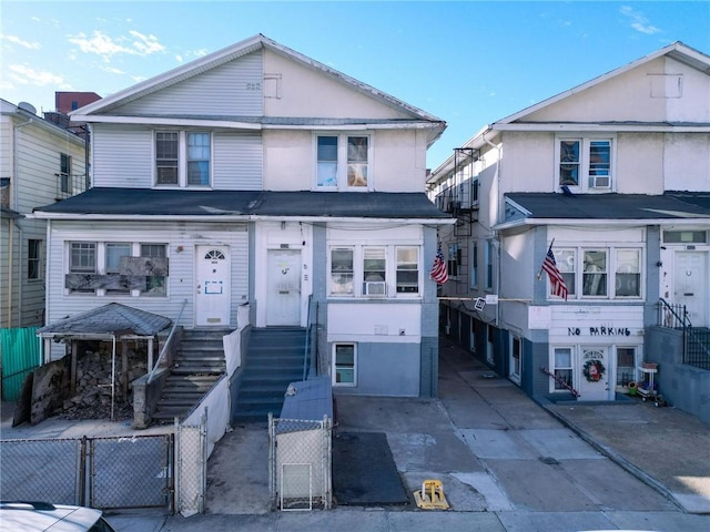 3024 Brighton 6th St, Brooklyn, NY 11235 - view of front of property with a gate, a fenced front yard, and stucco siding