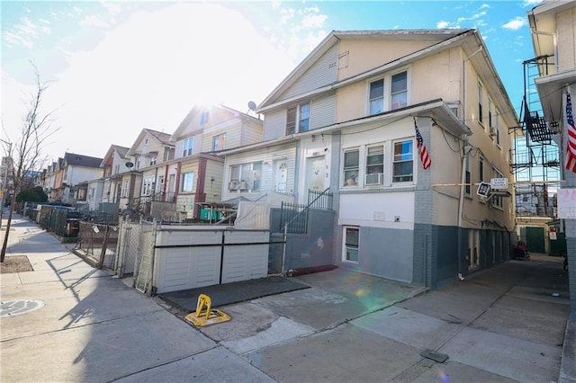 view of front of home featuring stucco siding and a residential view