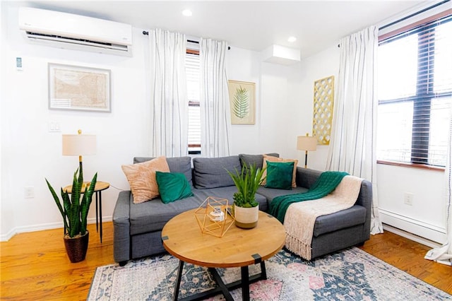 living room with hardwood / wood-style floors and a wall mounted AC