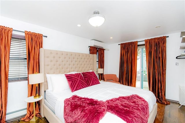 bedroom with baseboard heating, wood-type flooring, a wall mounted AC, and access to outside