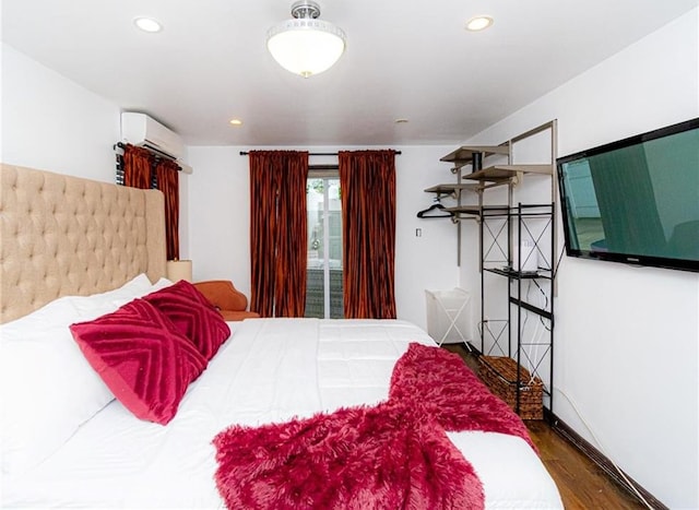 bedroom with dark wood-type flooring and a wall mounted AC