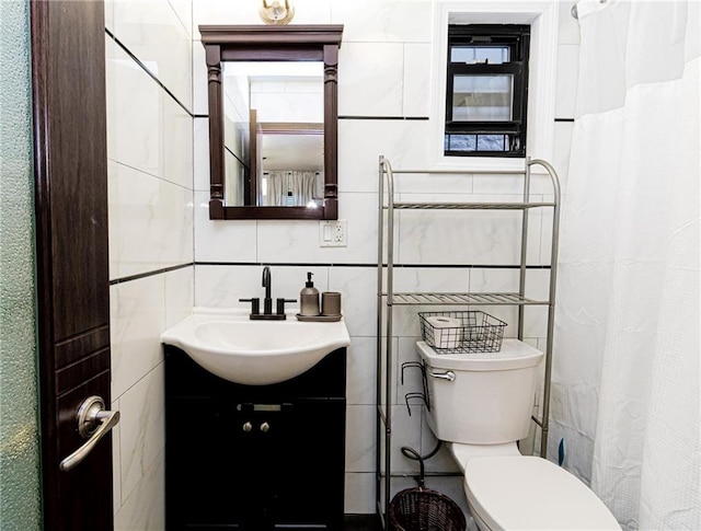 bathroom featuring tile walls, toilet, and vanity