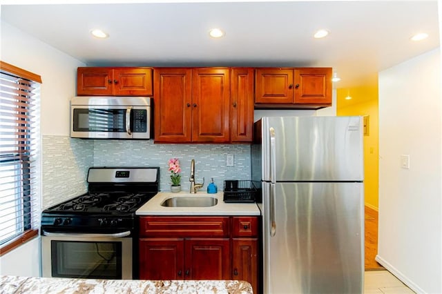 kitchen featuring sink, appliances with stainless steel finishes, plenty of natural light, and tasteful backsplash