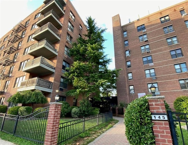 view of building exterior with fence