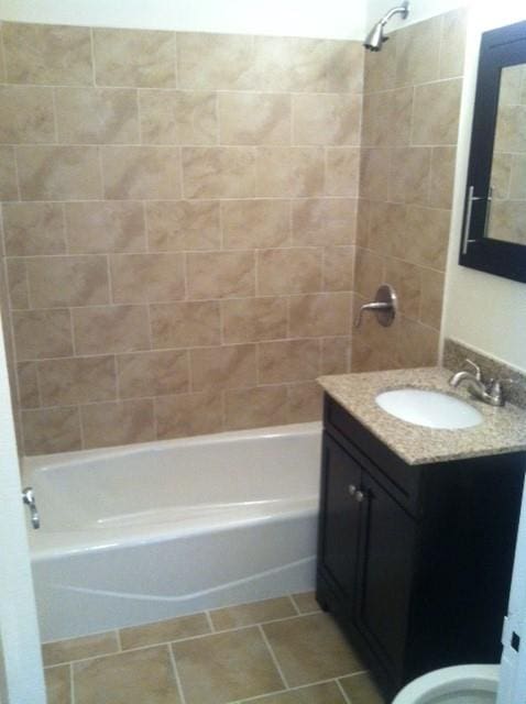 bathroom with vanity,  shower combination, and tile patterned flooring