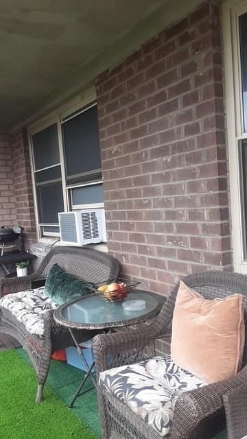 view of patio featuring cooling unit and a porch