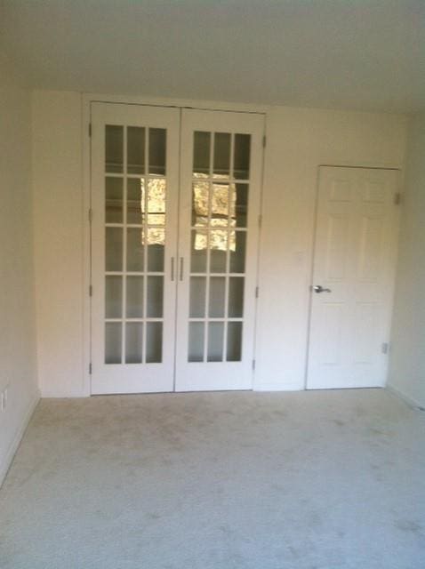 property entrance with french doors and stucco siding