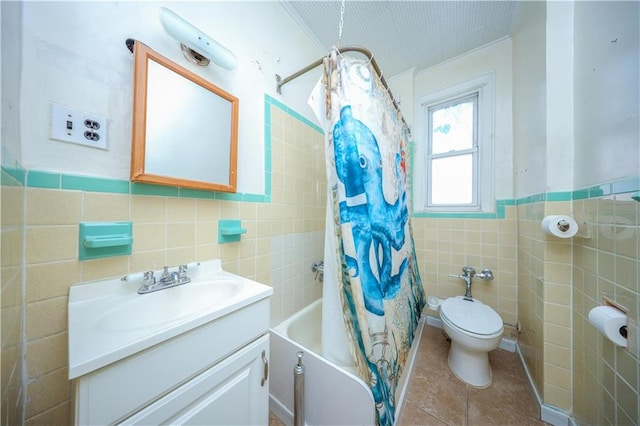 full bathroom with toilet, vanity, tile walls, tile patterned floors, and shower / bathtub combination with curtain