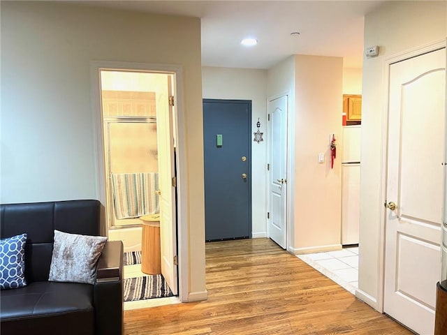 hall with light wood-type flooring