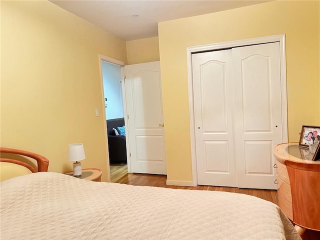 bedroom featuring hardwood / wood-style floors and a closet