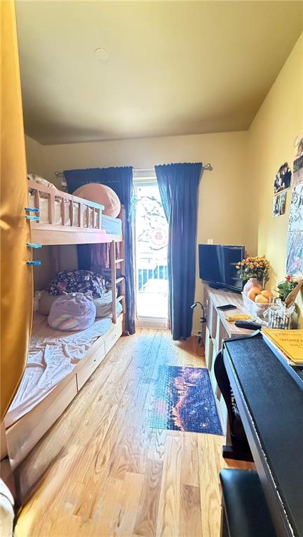 bedroom with wood-type flooring