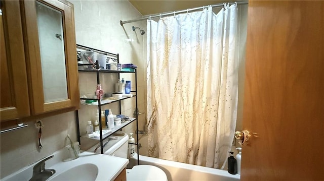 full bathroom featuring vanity, toilet, and shower / bath combo with shower curtain