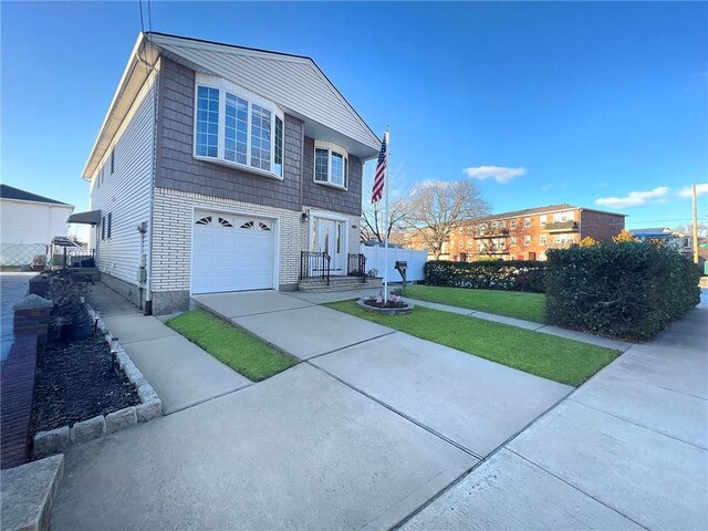 view of front of home with a garage and a front lawn