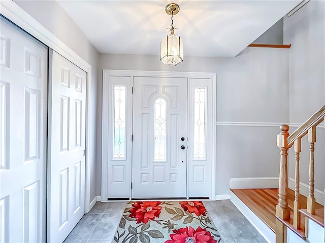 entrance foyer featuring tile patterned floors and a wealth of natural light